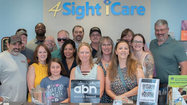 A photo of the happy community served by 4Sight iCare, all standing behind the front desk